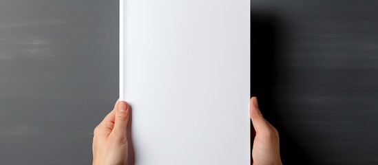 Mockup of a blank white journal being held displaying a softcover A4 book with clear magazine template With copyspace for text - obrazy, fototapety, plakaty