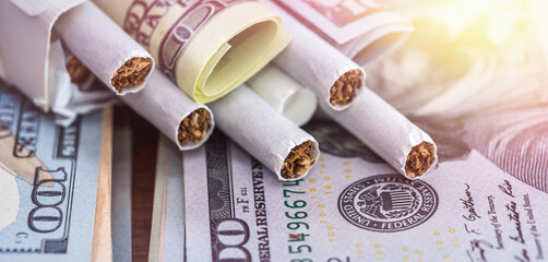 tobacco cigarettes on dollar bills. Concept of increase in the price of cigarettes