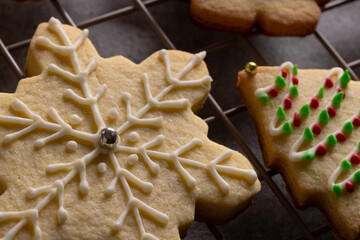 Close up of decorated christmas cookies with copy space on grey background