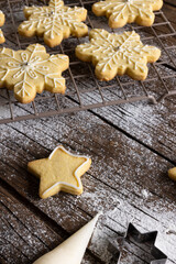 Vertical image of close up of christmas cookies with flour and copy space on wooden background