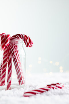 Naklejki Vertical image of jar of christmas candy canes with copy space on white background