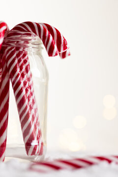 Naklejki Vertical image of jar of christmas candy canes with copy space on white background