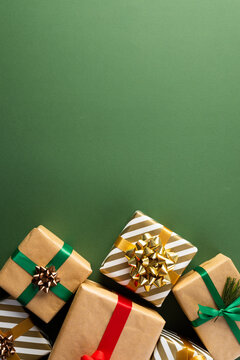 Vertical image of christmas presents with copy space on green background
