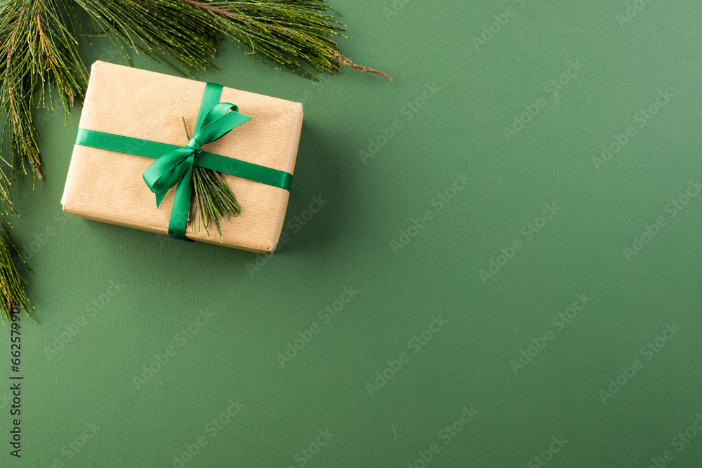 Poster Christmas presents with green ribbon and copy space on green background