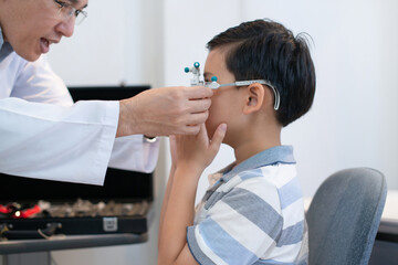 Optometrist used trial frame to check the boy's vision