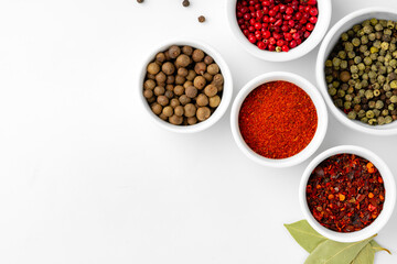 Various spices in a bowls on white background