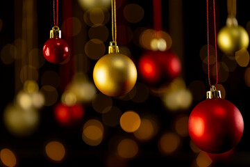 Red and gold christmas baubles with copy space on black background