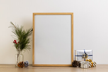 Christmas decorations and wooden frame with copy space on white background