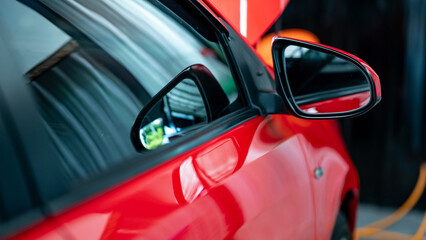 Detail of car door handle on the new red modern car. Land vehicle part design. automotive industry...