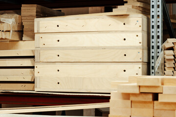 Stacked wooden bars in workshop of furniture manufacture