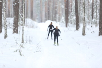Cross country skiing through a beautiful winter wonderland. Skier in blur betwwen the pines