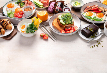 Fototapeta na wymiar Healthy breakfast eating concept, various morning food on light background