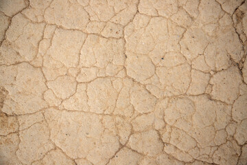 a close-up with dried beaten mud. Dry arid soil due to drought, climate change