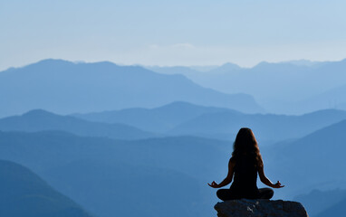 Silhouette of a Young Woman Practicing Yoga in a Beautiful Landscape