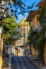 cozy street and the dome of the Tsminda Sameba Cathedral in the old part of Tbilisi, Georgia