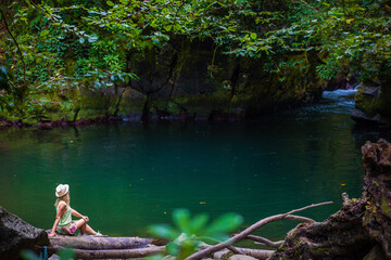 Girl traveler visits lake in Mtirala National Park, Georgia, Adjara