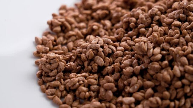 Cereal cocoa crunch choco flakes on a white ceramic dish close up. Dietary healthy food
