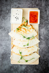 crispy flatbreads stuffed with meat, herbs, lime and two sauces, top view