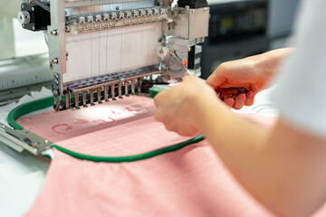 Close up of embroidery machine making patterns on textiles