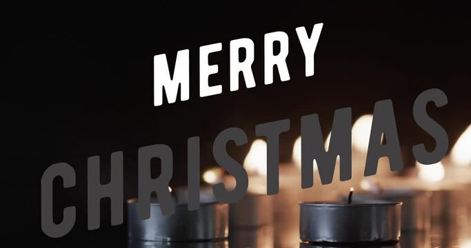 Animation of merry christmas text over lit tea candles on black background