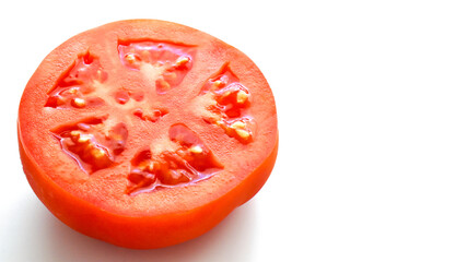 Tomato in half on white background. Healthy and dietary food concept. Copy space is on the right.