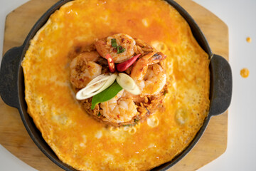 Shrimp chili paste fried rice and lava omelette in a hot wok dish
