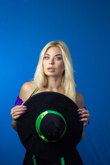 Blonde woman in black witch hat wearing costume for Halloween