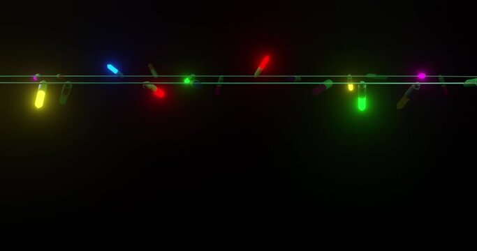 Strand of coloured christmas string lights flashing on black background, copy space