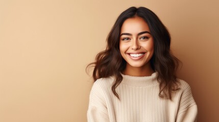 A teenage girl as she confidently poses against a light studio backdrop, her smile lighting up the frame.