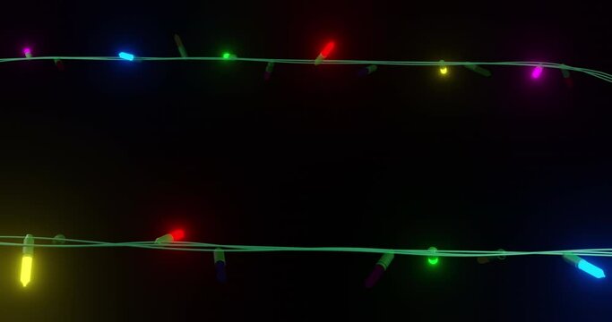 Coloured christmas string lights flashing on black background, copy space