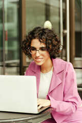 Confident stylish middle eastern woman, freelancer using laptop computer