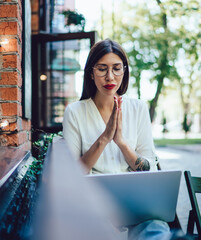 attractive woman checking blog statistic during leisure time in coworking street terrace