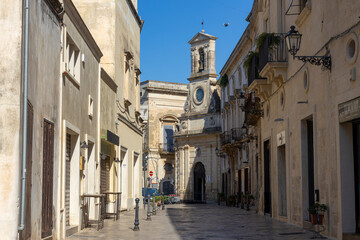 GALATINA, ITALY, JULY 16, 2022 - View of the ancient clock tower in the center town of Galatina, province of Lecce, Puglia, Italy