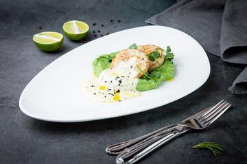 cheesecakes with creamy sauce on broccoli puree, side view