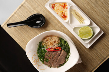 Pho Bo soup with beef, onion, fresh chilli herb and vegetables