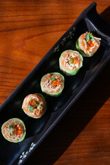 Sushi roll with salmon and shrimps on a sushi tray