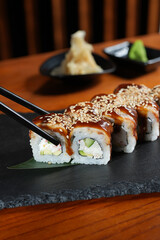 Sushi roll with salmon and shrimps on a sushi tray