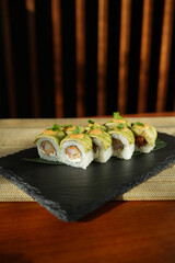 Sushi roll with salmon and shrimps on a sushi tray