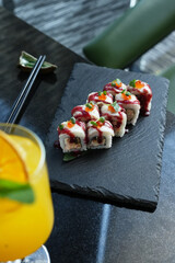 Sushi roll with salmon and shrimps on a sushi tray