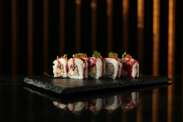 Sushi roll with salmon and shrimps on a sushi tray