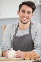 happy man and dough in the kitchen