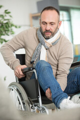 Fototapeta na wymiar mature handicapped man lifting his leg into position on wheelchair