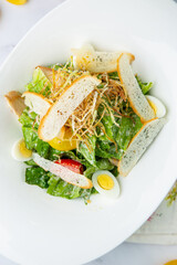 salad with quail eggs, cherry tomatoes, lettuce and breadcrumbs, top view