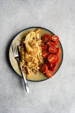 Close-up of an omelette with fresh cherry tomatoes