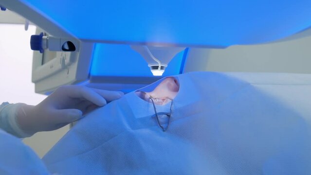 Laser eye correction using SMILE method. Laser moves down to patient eye.