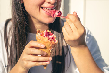 Portrait of happy caucasian brunette woman, eating ice-cream cone.