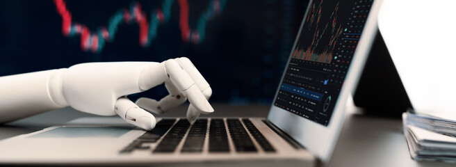 Automated stock trading concept. Robotic hand analyzing financial data on stock exchange,...