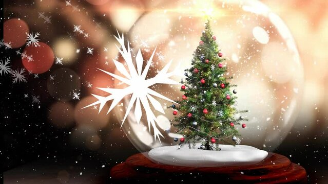 Animation of snowflakes and snowfall over decorated tree in glass sphere against lens flares