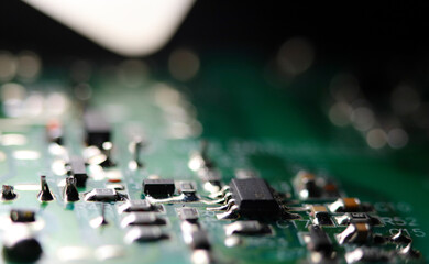 Green electronic circuit board close up. Macrophotograph.