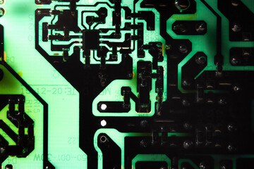Glowing electronic circuit board close up. Technology macrophotograph.
